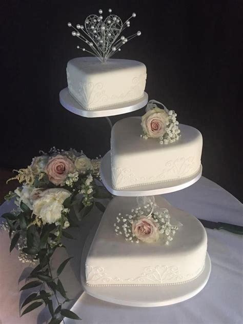 Heart Shaped Wedding Cakes On Three Tier Cake Stand Decorated With