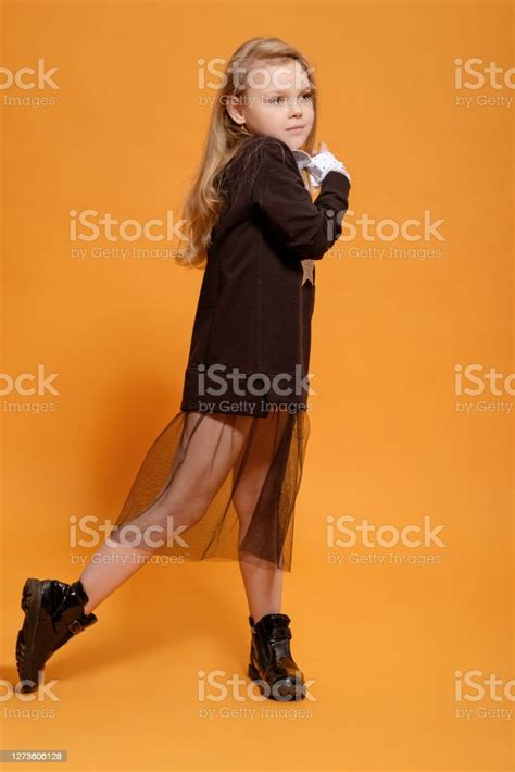 Fashion Model Beautiful Girl In Black Dress On A Yellow Background