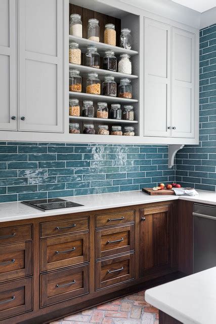 A dash of bold paint on the walls can really bring your kitchen to life. Stained base cabinets with light gray wall cabinets ...