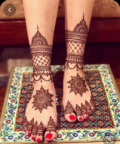 The Legs And Feet Of A Woman With Henna Tattoos