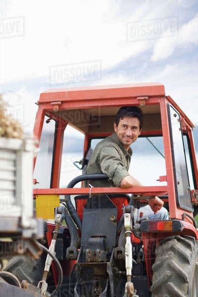Farmer In His Tractor Stock Photo Dissolve