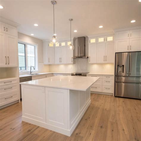 the white shaker cabinets countertops and backsplash the stainless steel appliances and