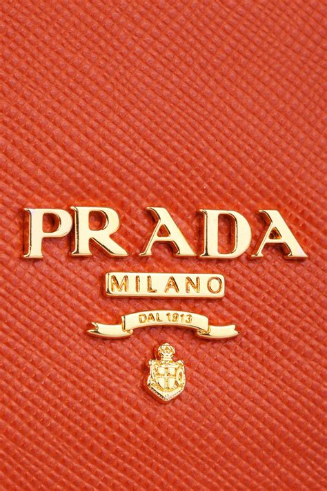 Newwall are proud to announce the new addition of maison neva to our portfolio of brands. Prada Orange Bag Logo (detail) | Fashion logo branding ...