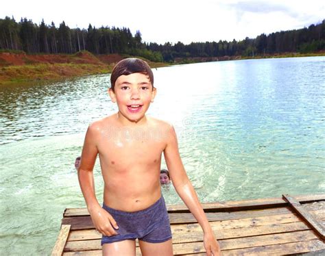Boy Swimming In The Lake On Their Summer Country Holiday Stock Photo
