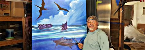 A Man Standing In Front Of A Painting With Seagulls Flying Over The Ocean