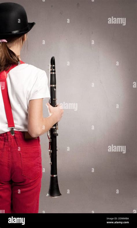 Little Girl Playing Clarinet On A Gray Background Stock Photo Alamy