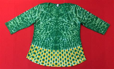 green krackle with deep yellow and green checkerboard hem three quarter sleeve scoop neck top