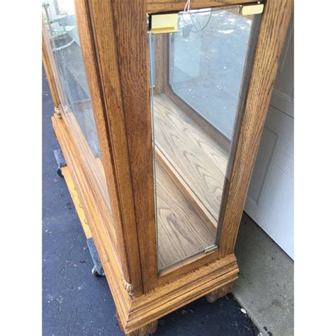 Beveled glass on the front door. Pulaski Oak Mirrored Curio Display Cabinet | Chairish