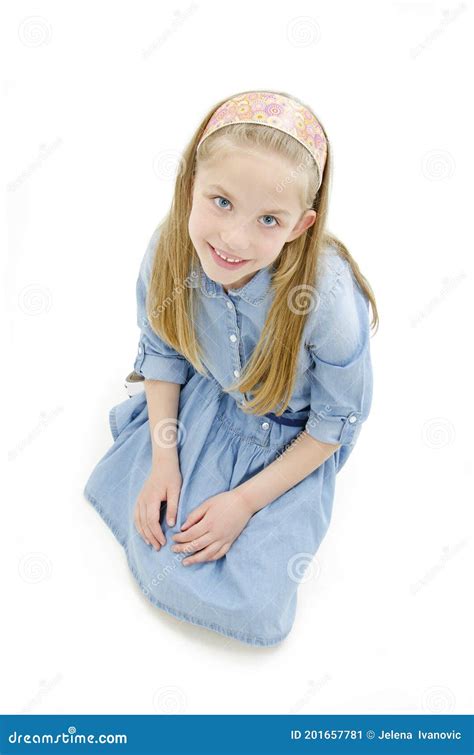 Portrait Of A Cute Girl Sitting On The Knees Looking Up Stock Image Image Of Casual Beauty