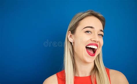 Excited Joyful Happy Blonde Woman Portrait On Yellow Background Heart