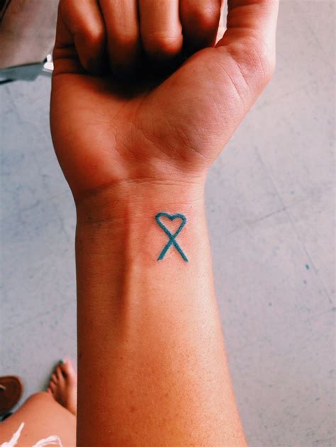 This cancer ribbon tattoo looks creative and has a got a spiritual touch in the form of little cross dangling i fought ovarian, uteran and breast cancer and recently added this tatoo for myself. Pin by Kristin Hester on Tattoo | Pinterest | Cancer ...