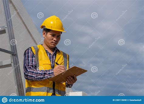 An Architect Engineer In A Work Uniform With A Construction Helmet And
