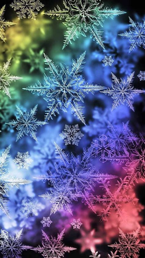 Snowflakes Are Arranged In Rainbow Colors On A Black Background