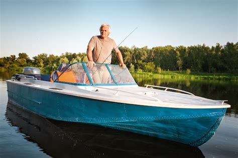 Premium Photo Mature Man On A Motor Boat Fishing