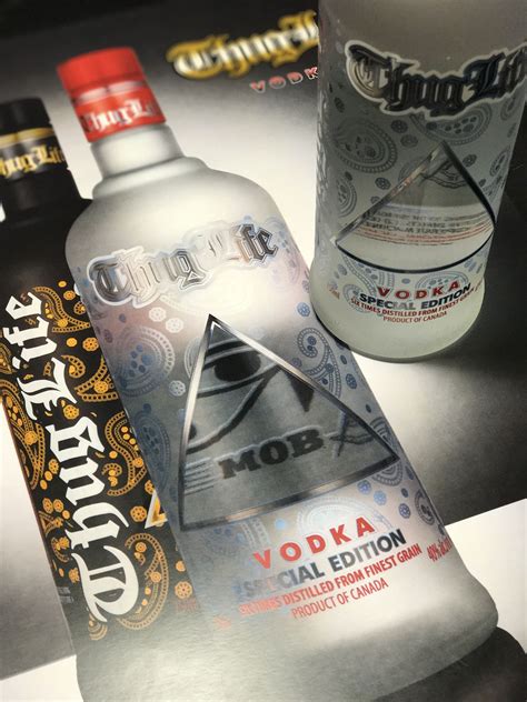 Two Bottles Of Vodka Sitting Next To Each Other On Top Of A Metal