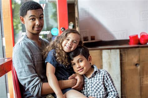 Mixed Race Brothers And Sister Smiling Together Stock Photo Dissolve