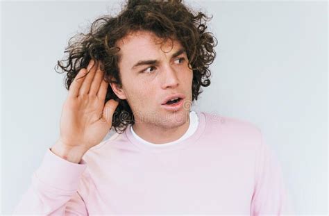 Closeup Portrait Of Amazed Eavesdropping Male With Curly Hair Placing