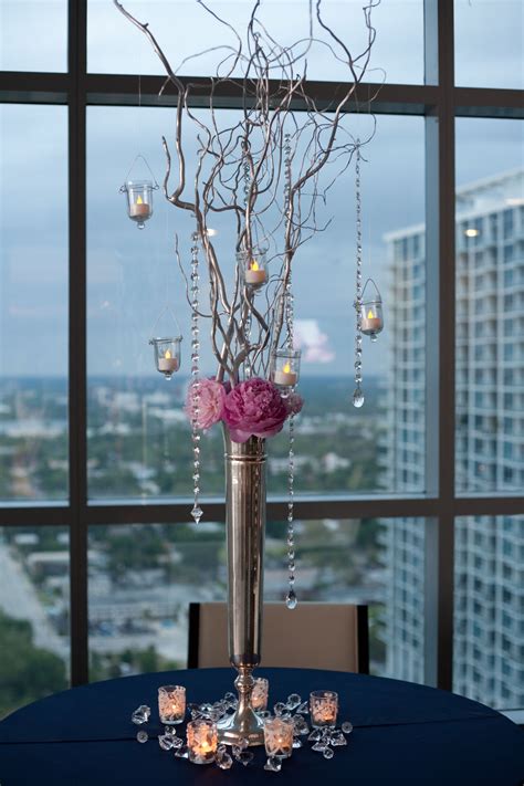 Tall Silver Vase With Sticks Crystals Hanging Candles And Pink