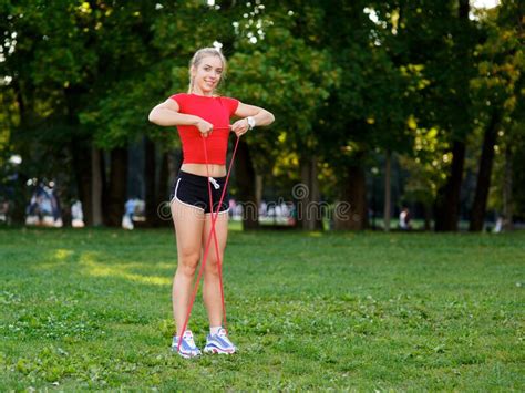Young Woman Is Training With Rubber Bands Outdoors Healthy Active Lifestyle Concept Stock Image