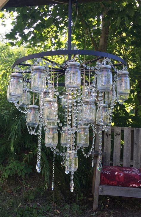 A Chandelier Made Out Of Mason Jars And Hanging From A Wooden Bench In
