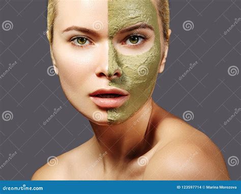 beautiful woman applying green facial mask beauty treatments close up portrait of spa girl