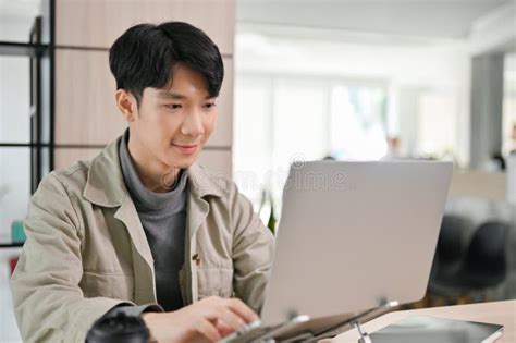 Handsome Asian Male Office Worker Or Developer Working On His Task On