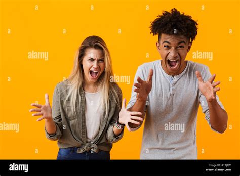 Image Of Agressive Screaming Young Cute Loving Couple Posing Isolated Over Yellow Background