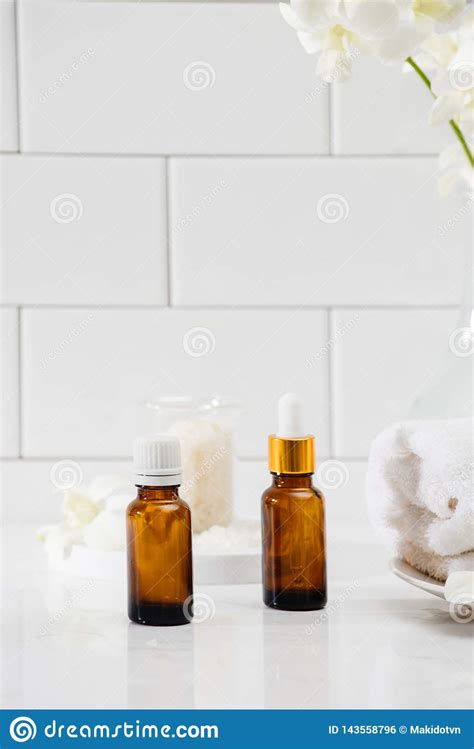 Bottles With Massage Essentials Oils Towels And Zen Stones Spa