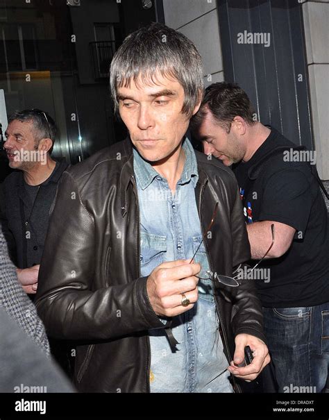 Ian Brown Holding His Spectacles Stone Roses Arrive At Their Hotel