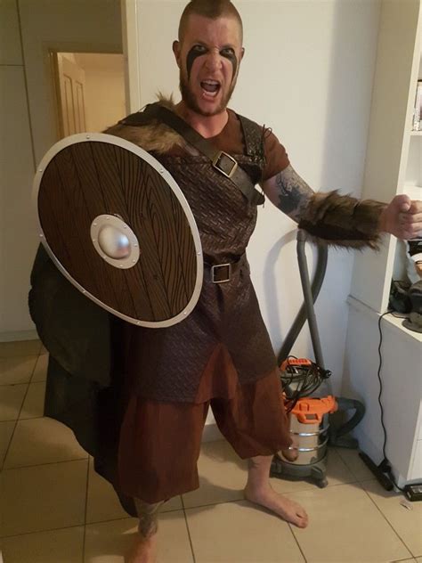 A Man Dressed As A Viking Holding A Shield