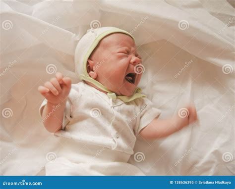 Little Newborn Baby Girl Screams Loudly And Heart Rending Stock Image