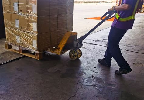 Worker Loading And Unloading Shipment Carton Boxes And Goods On Wooden