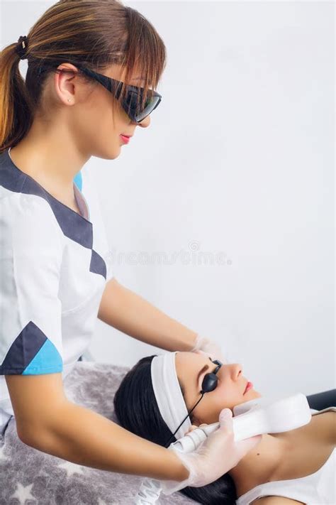 Face Care Facial Laser Hair Removal Beautician Giving Laser Epilation Treatment To Young Woman
