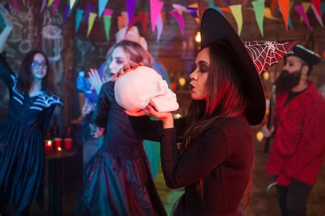 Premium Photo Attractive Woman Dressed Up In A Witch Costume Kissing