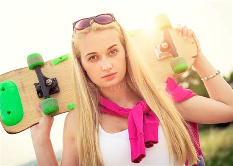 Hipster Teenage Girl With Skateboard Image With Sunflare Stock Photo