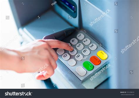 Close Up Of Hand Entering Pinpass Code On Atmbank Machine Keypad