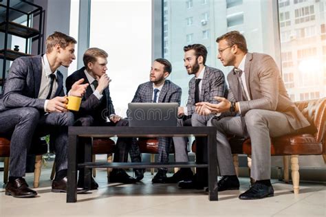 Young Men In Suits Gathered In Business Meeting Stock Photo Image Of