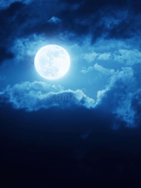 Dramatic Moonrise Background With Deep Blue Nightime Sky And Clouds