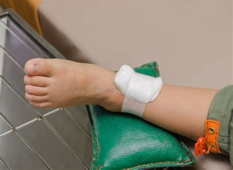 Child Boy With Bandage On Leg And Lying Down Hospital Bed Stock Image
