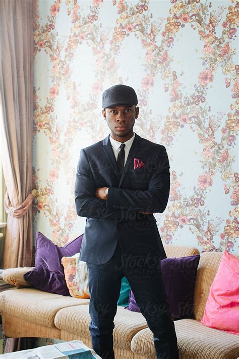 Stylish Young Black Man Standing In Bright Beautiful Living Room By