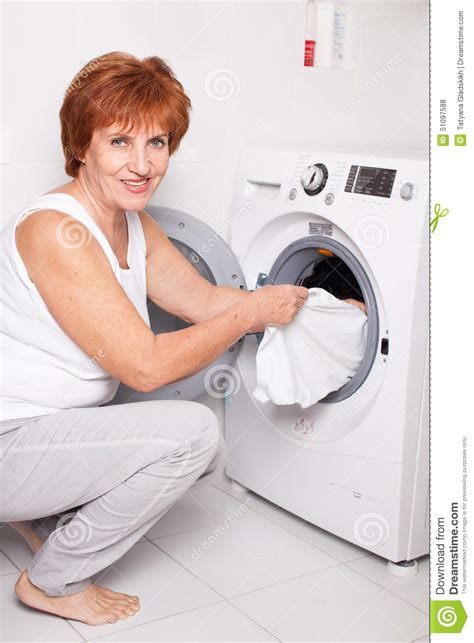 Woman Puts Clothes In The Washing Machine Stock Photo Image Of