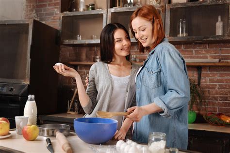 Positive Delighted Lesbians While Cooking Stock Image