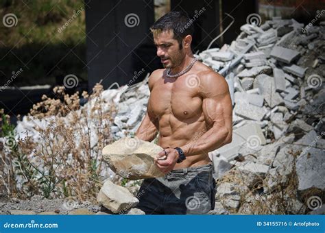 Muscular Construction Worker Shirtless In Building Site Stock Photo