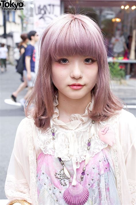 A Woman With Pink Hair And Bangs Standing In The Street
