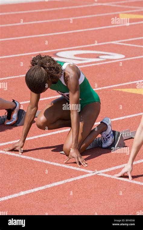 Female Athletes In Starting Blocks Ready To Run Stock Photo Alamy