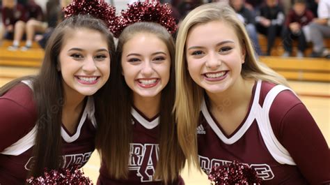 Three Cheerleaders Wearing Maroon Cheer Outfits Background Picture Of Cheerleaders Background