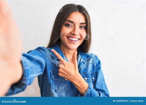 Beautiful Woman Wearing Denim Shirt Make Selfie By Camera Over Isolated White Background