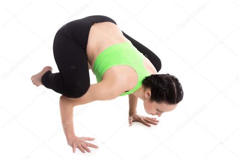 Bakasana or crane pose will increase mental and physical strength. Bakasana Images / Young Woman Is Doing Yoga Exercise ...