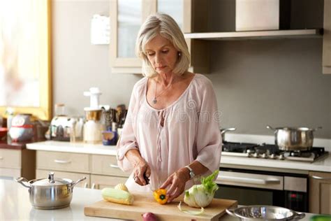 Older Woman In Kitchen Preparing Healthy Meal Stock Image Image Of
