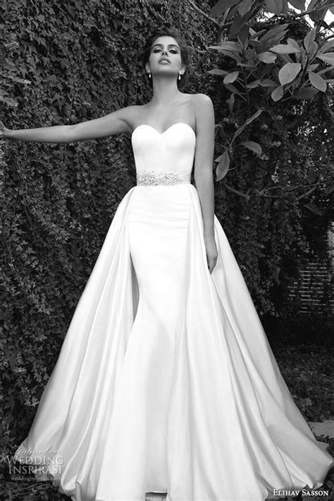 A Black And White Photo Of A Woman In A Wedding Dress With Her Arms Out